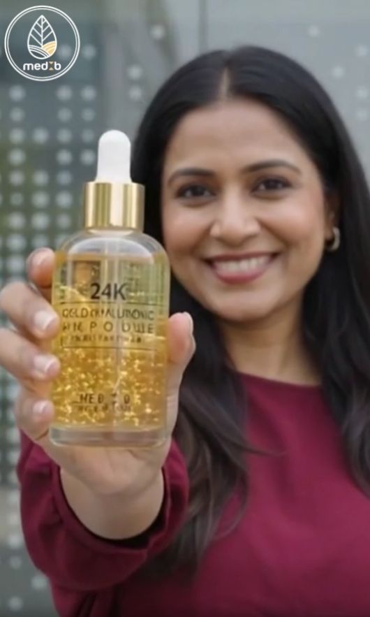 A woman holds a bottle of MEDB Premium 24K Gold Hyaluronic Acid Ampoule, promoting K-Beauty skincare in Bangladesh as the sole distributor.