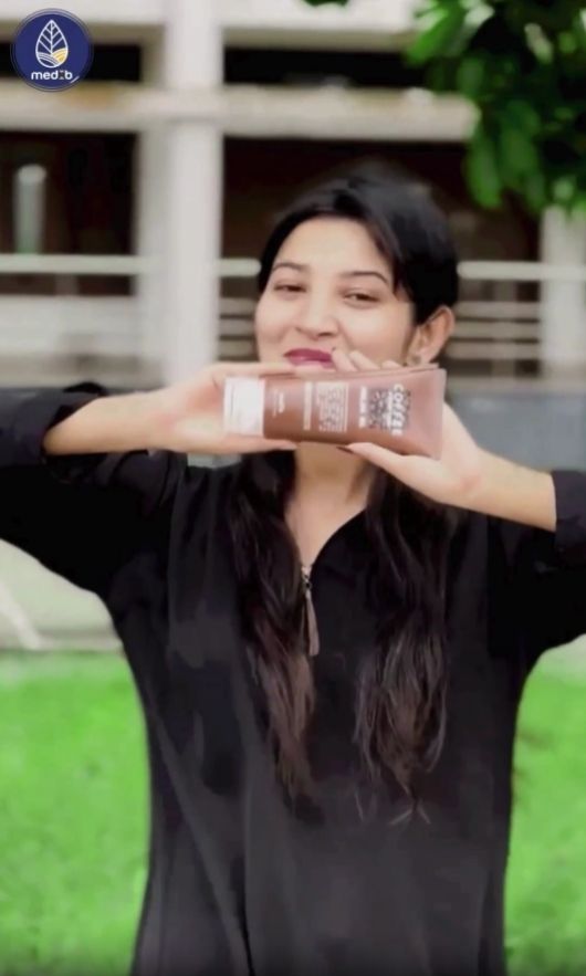 A woman holds a bottle of MEDB Coffee Purifying Peeling Gel, highlighting its K-Beauty branding and authenticity.