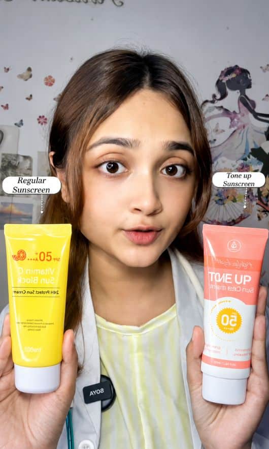 Woman comparing two sunscreens: MEDB Daylight Tone Up and Vitamin C 24H Protect, showcasing Korean skincare options.